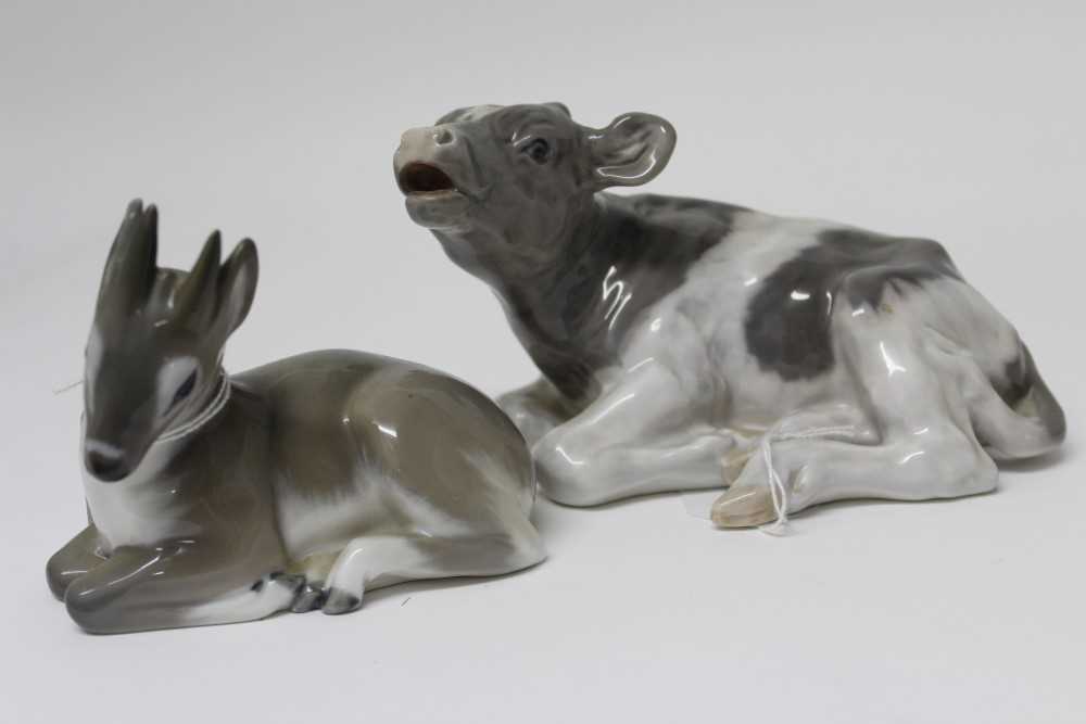 Lot 2068 - Two Royal Copenhagen porcelain models – calf lying down no. 1072 and deer fawn no. 2648