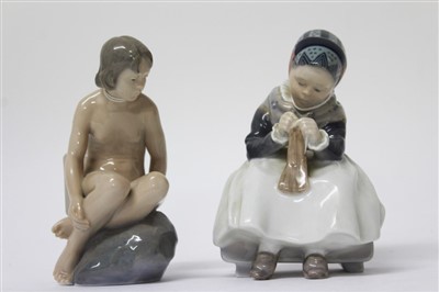 Lot 2071 - Two Royal Copenhagen figures – nude girl on rock no. 4027 and Amager girl sewing no. 1314