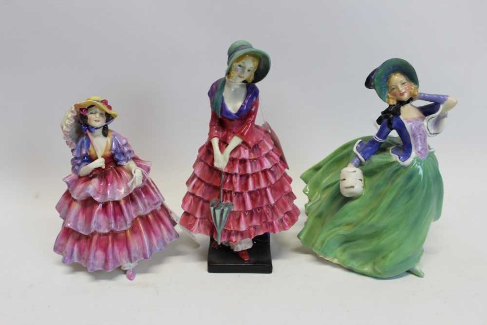 Lot 2079 - Three Royal Doulton figures – The Hinged Parasol HN1578, Priscilla HN1340 and Autumn Breezes HN1913