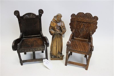 Lot 3502 - Two miniature carved oak chairs in the form of 17th century Wainscot chairs, together with a carved figure of Saint Francis of Assisi (3)