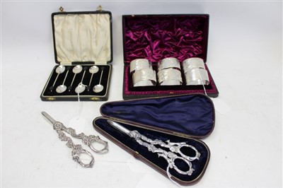 Lot 3595 - Cased set of six Victorian silver oval napkin rings with engraved foliate decoration, numbered 1 – 6 (Birmingham 1862), together with a set of six silver coffee bean spoons (Birmingham 1932) and tw...