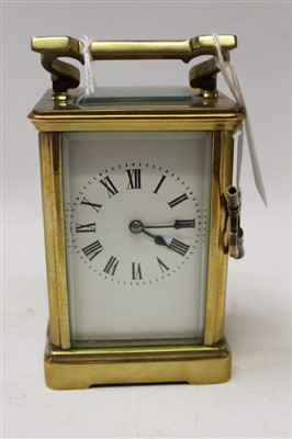 Lot 3620 - Late 19th / early 20th century carriage clock with French eight day movement and lever escapement striking on a gong, white enamel dial with Roman numerals in a gilt metal case