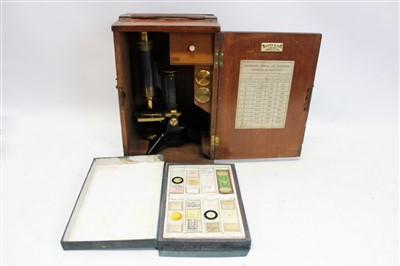 Lot 3623 - Winter & Son, Newcastle on Tyne, microscope with lenses, in a fitted case, together with a box of microscope slides (2)