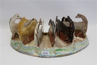 Lot 2111 - 20th century Ann Stokes art pottery five-division ornament decorated with six raised horses