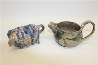 Lot 2112 - 20th century Ann Stokes art pottery jug with mottled green glaze and an Ann Stokes pottery box and cover in the form of a pig (2)