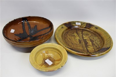 Lot 2113 - 20th century R. J. Lloyd art pottery circular charger decorated with a face and two other art pottery bowls