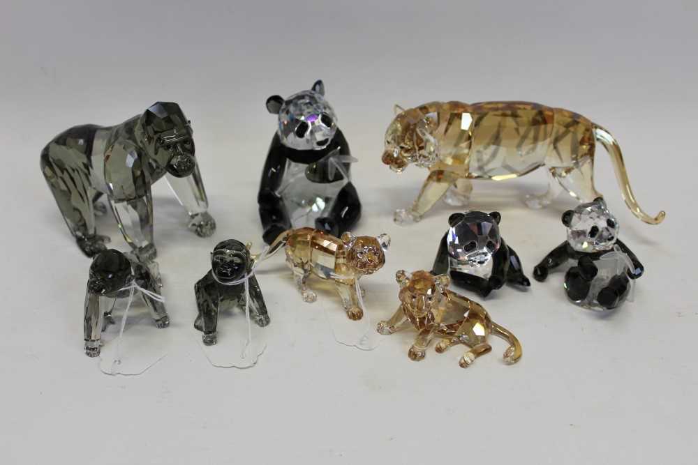 Lot 2122 - Five Swarovski crystal Endangered Wildlife figures - Panda and baby, Gorilla and baby and Tiger in three boxes with certificates