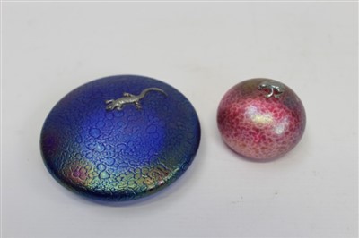 Lot 2126 - Heron iridescent blue glass paperweight with white metal lizard mount and another pink glass paperweight with white metal silver frog mount (2)