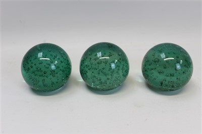 Lot 2133 - Three Edwardian green glass paperweights with bubble decoration