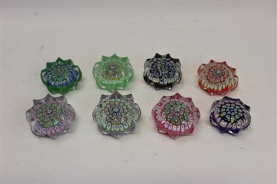 Lot 2138 - Eight John Deacons small star glass paperweights with millefiori decoration