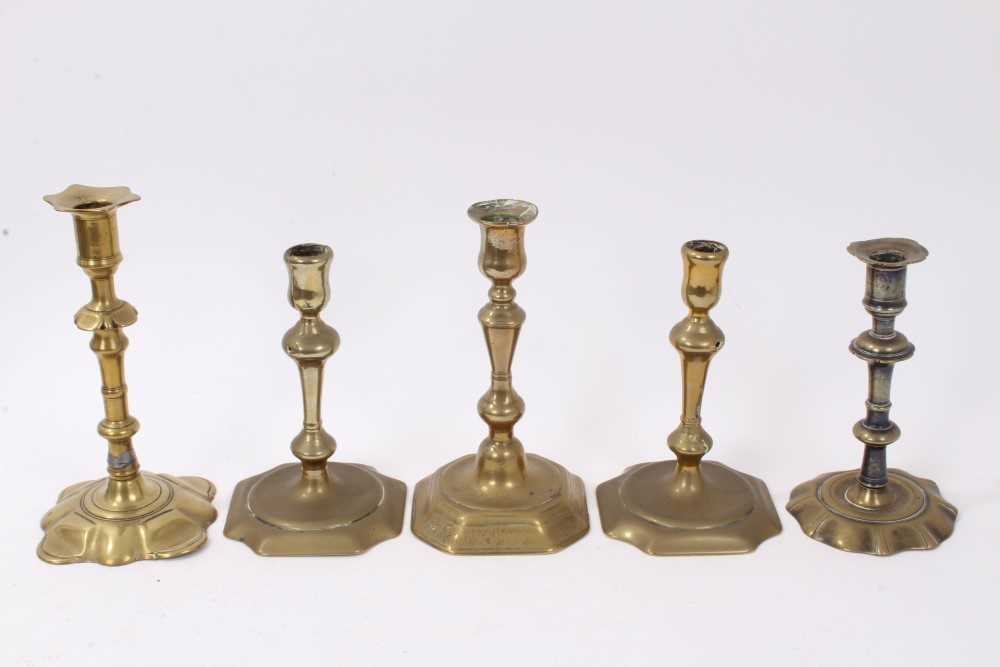 Lot 822 - Four early 18th century brass candlesticks