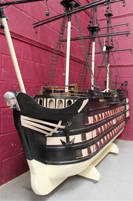Lot 1070 - Very large and impressive old painted wooden model of HMS Victory with removable sides and opening stern