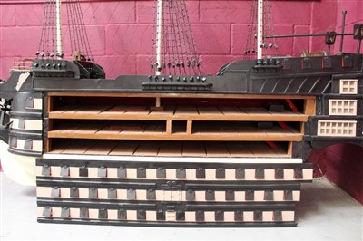 Lot 1070 - Very large and impressive old painted wooden model of HMS Victory with removable sides and opening stern