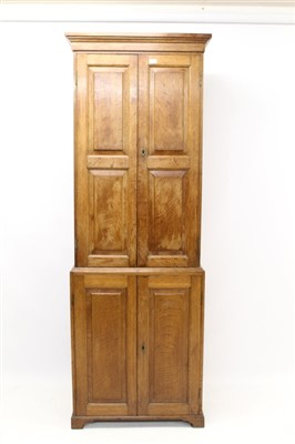 Lot 1428 - 19th century oak two-height cupboard, shelved interior enclosed by two pairs of fielded panel doors, on bracket feet, 74cm wide x 32cm deep x 216cm high