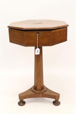 Lot 1434 - William IV figured oak worktable, octagonal radially veneered top hinged to reveal fitted interior, on flared column and triangular platform on squat bun feet, 45cm diameter