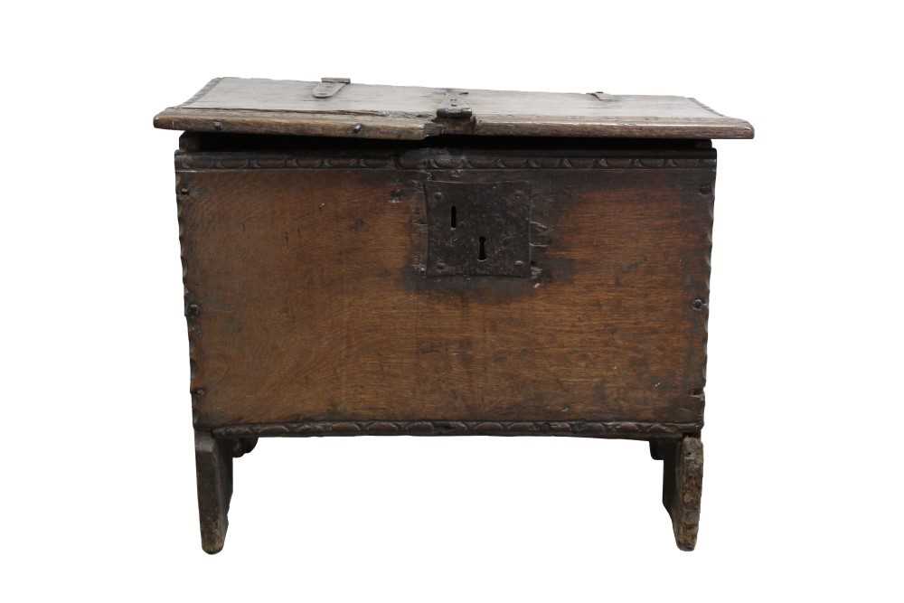 Lot 1448 - Early 17th century oak six-plank coffer of small proportions, with strap iron work and carved edging, 64cm wide
