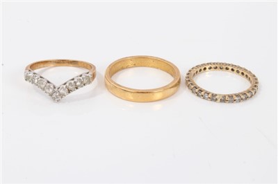 Lot 3305 - Yellow metal wedding band, diamond eternity ring and a wishbone ring (3)