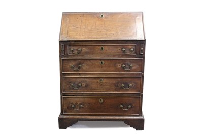 Lot 1449 - George III oak bureau of small proportions, with fall-front and four long graduated drawers with brass swan-neck handles, on bracket feet, 71cm wide