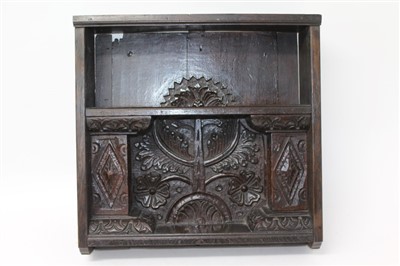 Lot 1453 - 17th century and later carved oak hanging shelf with foliate carved back and lozenge carved supports for the shelves, 48cm wide