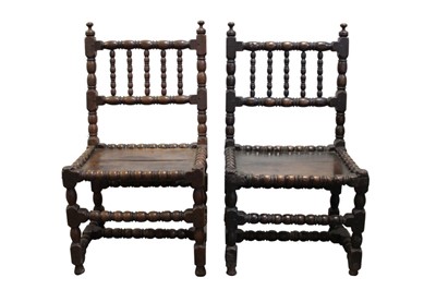 Lot 1455 - Pair of mid-17th century turned oak chairs with reel and bobbin-turned decoration, panelled seats on conforming supports and stretchers