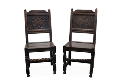 Lot 1456 - Matched pair of 17th century oak panelled back side chairs with panelled finials, scroll carved panelled back, with panelled seats on turned supports