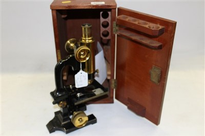 Lot 3807 - Swift Metallurgical microscope on black enamel stand, with single objective and eyepiece, fine and coarse focus adjustment and fitted wooden case