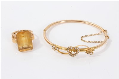 Lot 3423 - Victorian bangle with heart and leaf scroll decoration set with seed pearls, together with a citrine cocktail ring