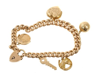 Lot 666 - 9ct rose gold charm bracelet with four gold charms and a gold-backed locket