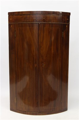 Lot 1514 - George III mahogany bowfront corner cupboard