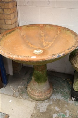 Lot 1580 - Terracotta garden bird bath with dished circular top on waisted pedestal base, 100cm diameter