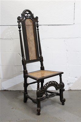 Lot 1475 - Charles II black lacquered and gilt-heightened beech and caned side chair with high arched caned back with scroll pierced cresting and stop-fluted columns, caned seat on Braganza legs, pierced arch...