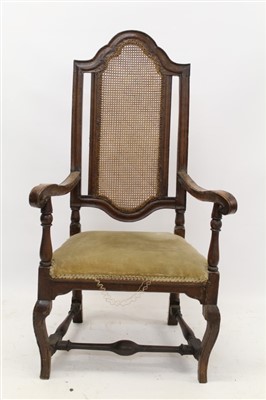 Lot 1476 - Early 18th century Continental walnut and caned open armchair, arched panel back and scrolling arms, with stuffover upholstered seat on squared cabriole legs and H-stretcher