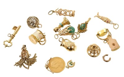 Lot 651 - Twelve gold / yellow metal charms and three gilt metal charms