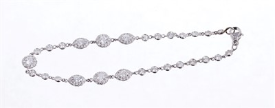 Lot 624 - Diamond bracelet comprising seven clusters of brilliant cut and marquise cut diamonds interspaced