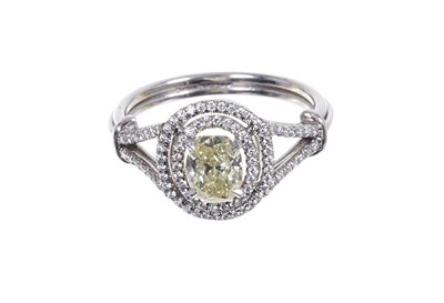 Lot 660 - Diamond double-halo cluster ring, natural fancy yellow oval brilliant cut diamond weighing 1.06cts