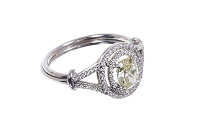 Lot 660 - Diamond double-halo cluster ring, natural fancy yellow oval brilliant cut diamond weighing 1.06cts