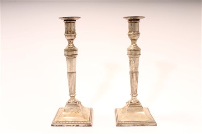 Lot 428 - Pair of white metal candlesticks on square bases