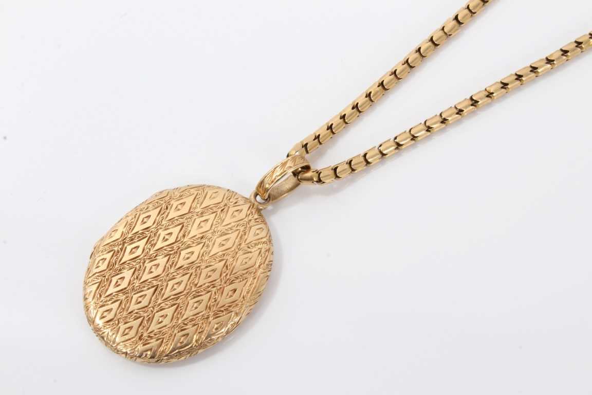 Lot 599 - Engraved gold locket on chain