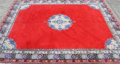 Lot 1675 - Early 20th Century North African wool pile carpet, fine weave, believed to be hand knotted, with medallion design on red ground