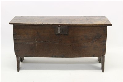 Lot 1543 - 18th century elm coffer of typical form with shaped end standards