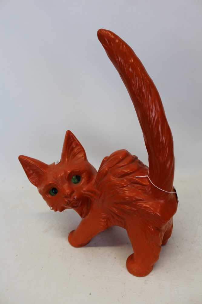 Lot 2026 - Mid twentieth-century pottery ornament of an over characterful cat with orange glazed body and green eyes 41.5cm high