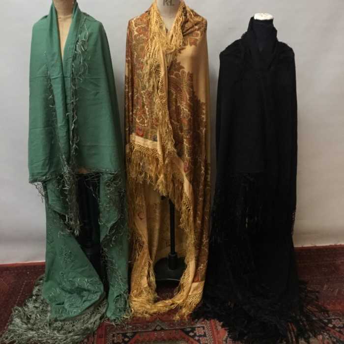 Lot 3061 - Victorian embroidered wool shawl with plaited and woven silk ribbon fringing plus a similar green wool shawl and a printed paisley shawl with silk fringing.