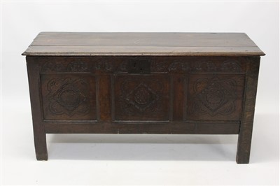 Lot 1605 - 17th century oak coffer with three panel carved front, hinged lid, on block feet