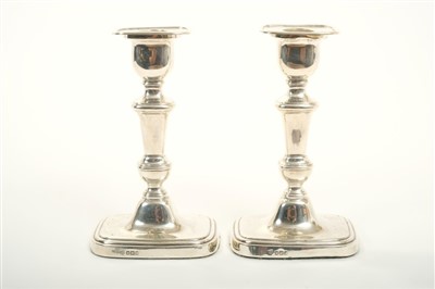 Lot 251 - Pair of George V silver candlesticks with knopped stems