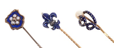 Lot 561 - Victorian enamel and pearl stick pin in the form of a snake, Victorian enamel and diamond fleur-de-lys stick pin and one other Victorian blue enamel stick pin (3)