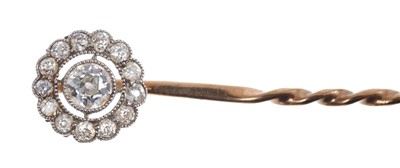 Lot 562 - Edwardian diamond stick pin with a circular openwork cluster of old cut diamonds in platinum millegrain setting on gold.  Estimated total diamond weight approximately 0.35 carats