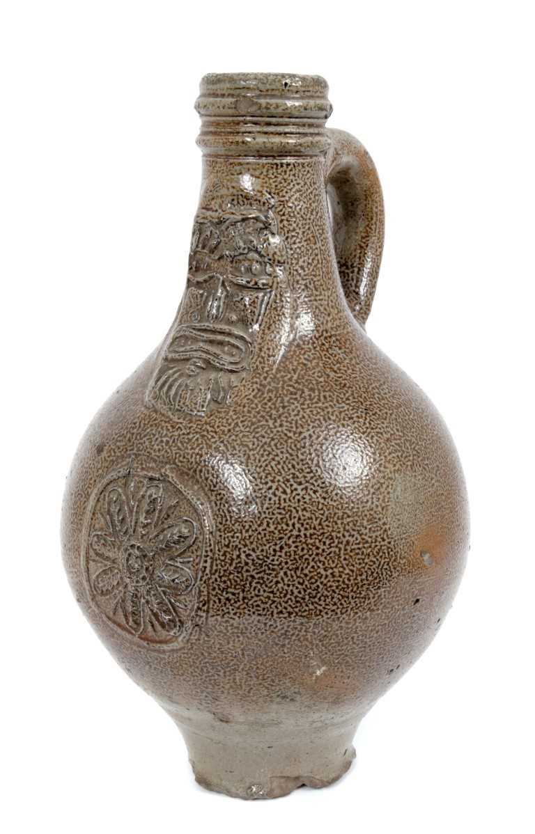 Lot 200 - 17th century Rhenish stoneware Bellarmine bottle with string collar, 23cm high