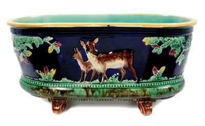 Lot 2157 - Victorian Majolica planter of oval form, with deer and tree decoration, raised on scroll feet
