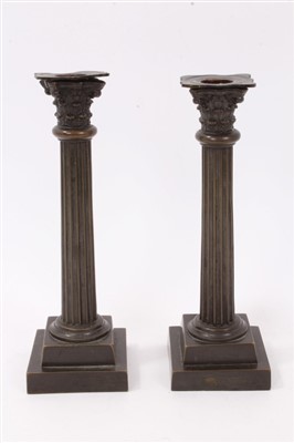 Lot 1047 - Pair of 19th century bronze Corinthian column candlesticks