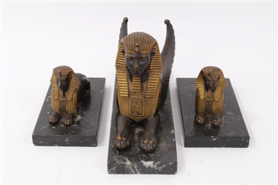 Lot 704 - Egyptian Revival bronze garniture of three sphinxes